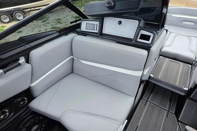 Slide: The Image of 2023 Supra SL 450 boat interior with gray seating and modern dashboard design. - 17