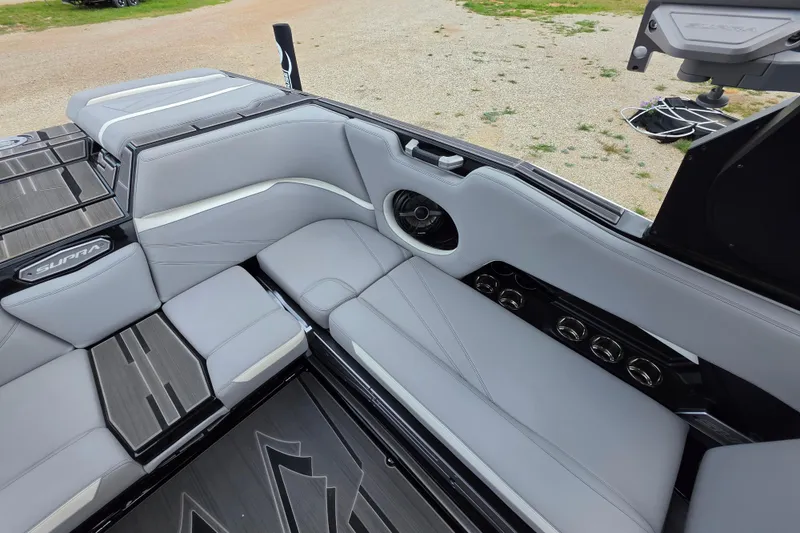 Slide: The Image of 2023 Supra SL 450 boat interior with sleek gray seating and modern design elements. - 19