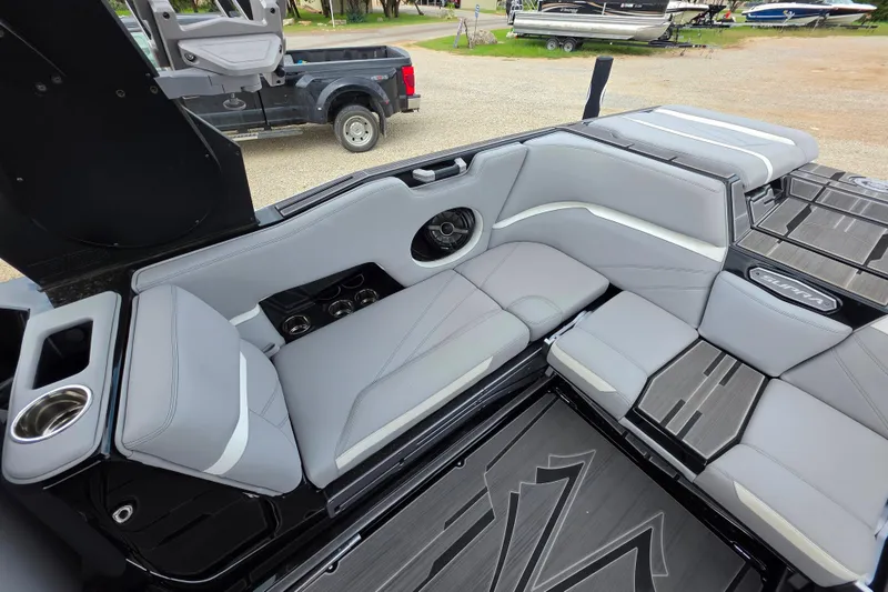 Slide: The Image of 2023 Supra SL 450 boat interior with sleek gray seating and modern design elements. - 20
