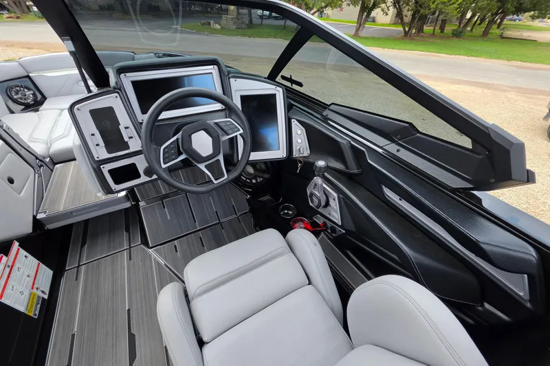 Slide: The Image of Interior of 2023 Supra SL 450 boat with modern dashboard and steering wheel. - 21