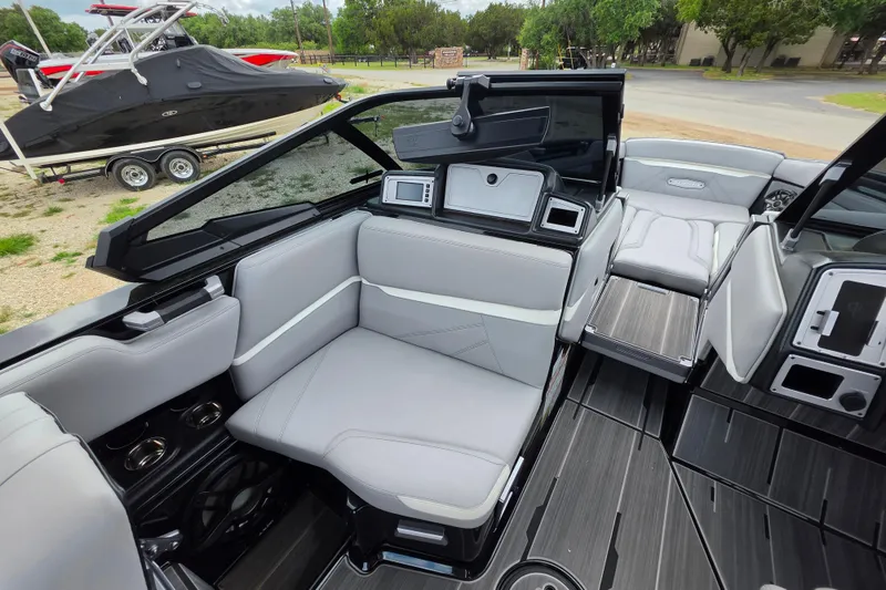 Slide: The Image of Interior of 2023 Supra SL 450 boat with sleek seating and modern dashboard. - 22