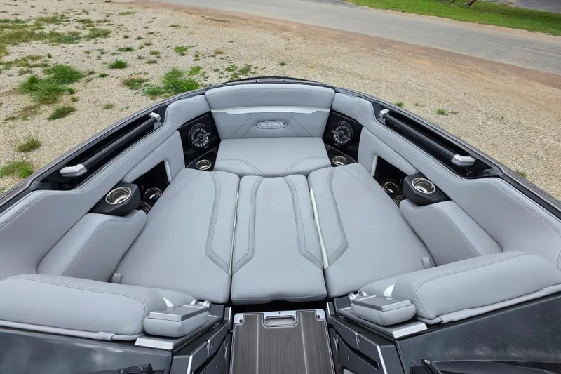 Slide: The Image of 2023 Supra SL 450 boat interior with luxurious gray seating and cup holders. - 23