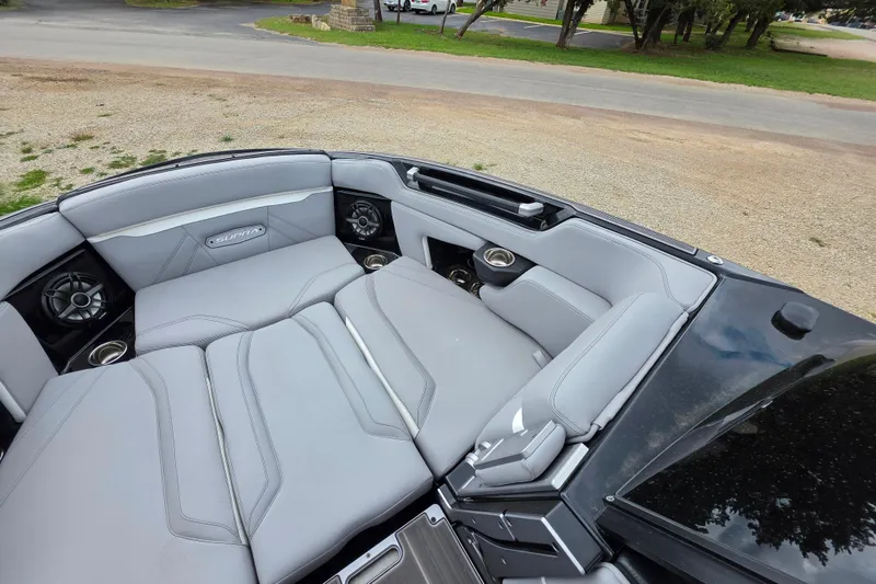 Slide: The Image of 2023 Supra SL 450 boat interior with gray seating and built-in speakers. - 24
