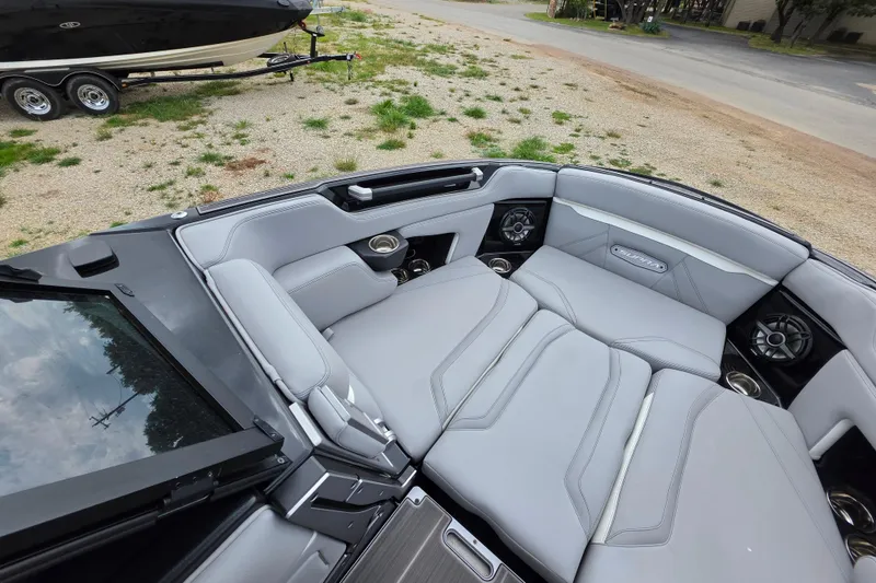 Slide: The Image of Luxurious interior of 2023 Supra SL 450 boat with plush seating and cup holders. - 25