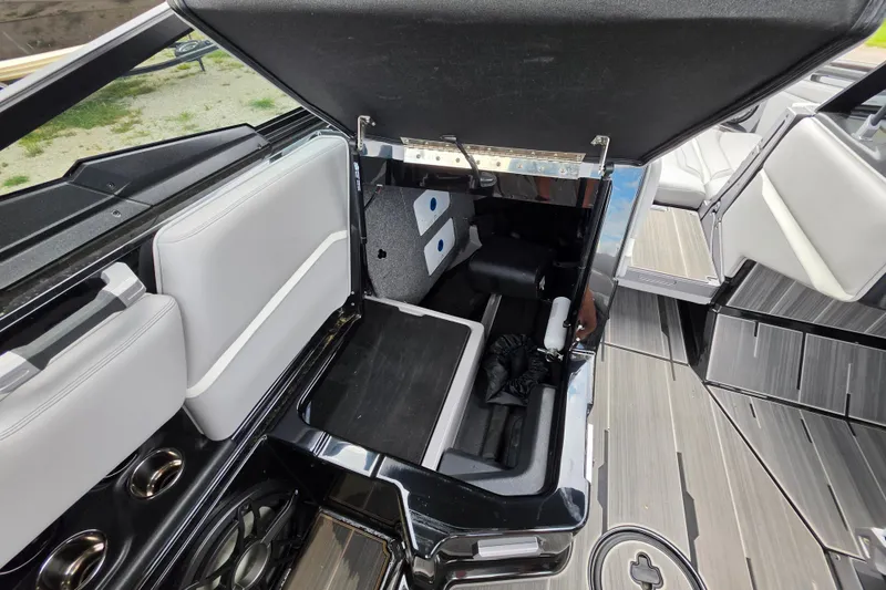 Slide: The Image of 2023 Supra SL 450 boat interior storage compartment with sleek seating and modern design. - 26