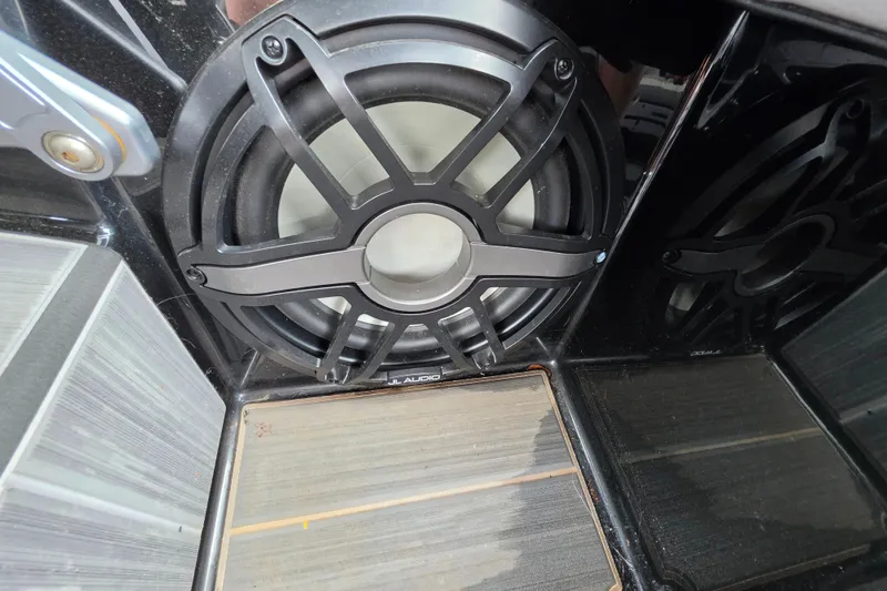 Slide: The Image of 2023 Supra SL 450 speaker system with JL Audio subwoofer in sleek interior design. - 27