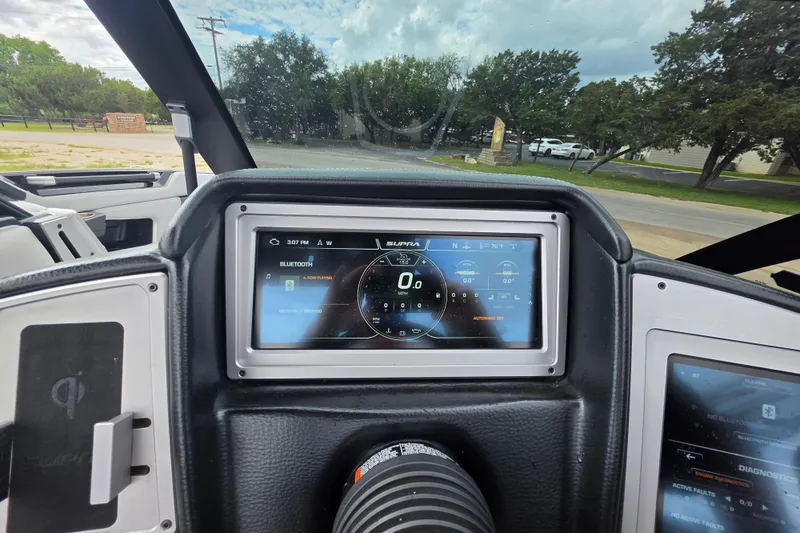 Slide: The Image of Dashboard of 2023 Supra SL 450 boat with digital display and Bluetooth connectivity. - 29
