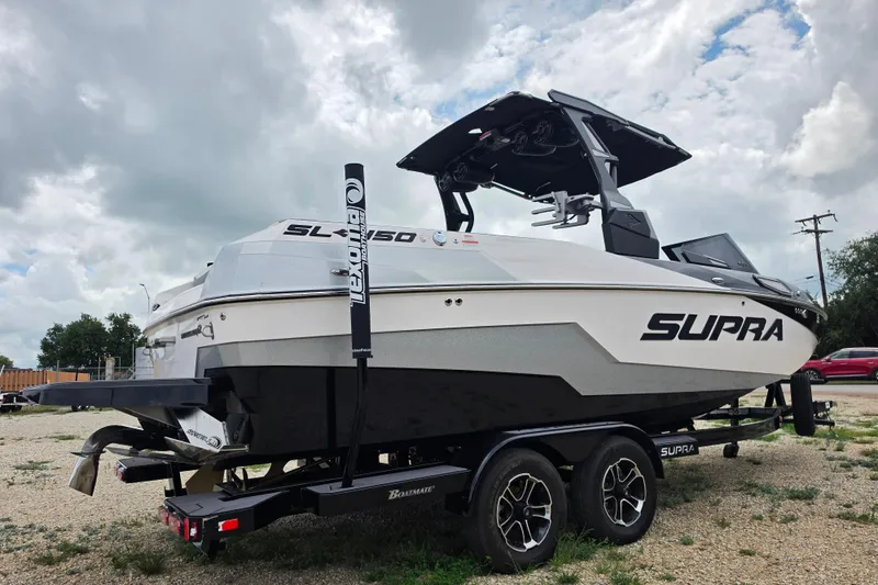 Slide: The Image of 2023 Supra SL 450 boat on trailer under cloudy sky. - 3