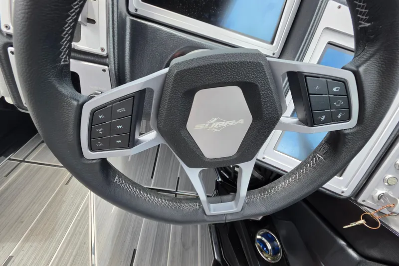 Slide: The Image of Steering wheel of 2023 Supra SL 450 with integrated controls and modern design. - 36