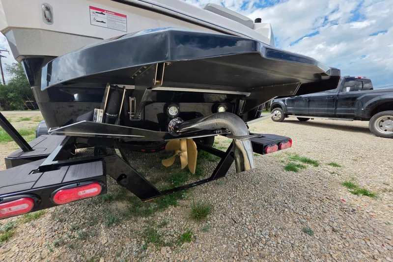 Slide: The Image of Rear view of 2023 Supra SL 450 boat on trailer, showing propeller and exhaust. - 37