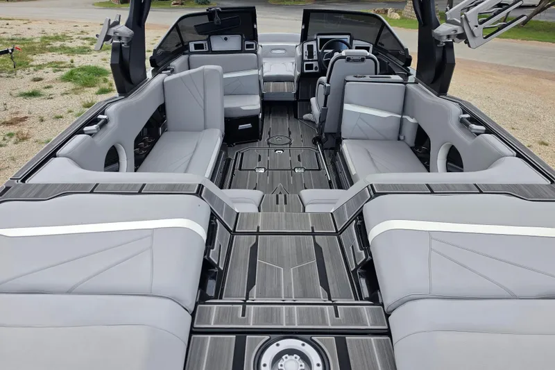 Slide: The Image of 2023 Supra SL 450 boat interior with sleek gray seating and modern design. - 8