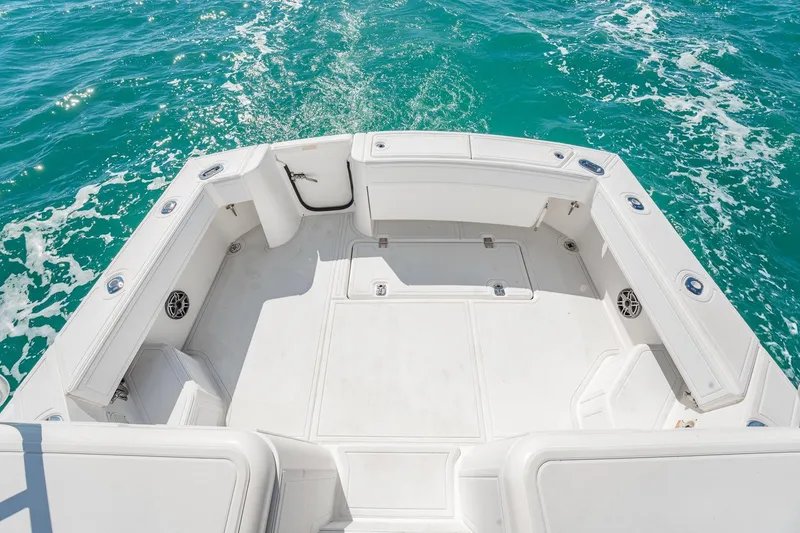 Slide: The Image of 2004 Luhrs Tournament 320 Open boat deck with ocean view, featuring spacious seating and storage. - 10