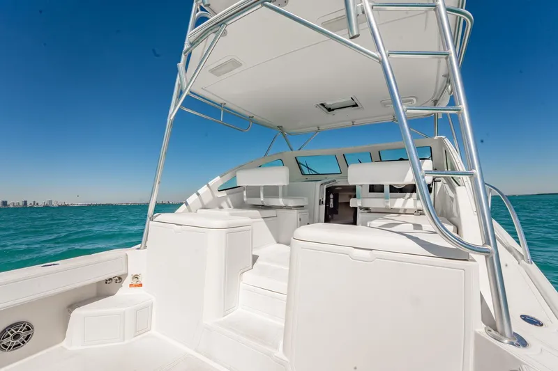 Slide: The Image of 2004 Luhrs Tournament 320 Open boat on clear blue water, showcasing spacious deck and seating. - 14