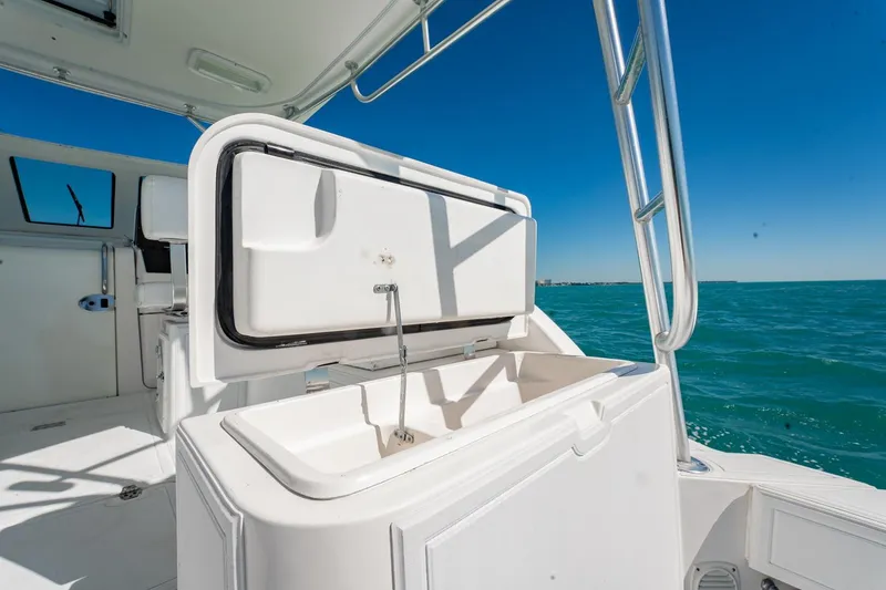 Slide: The Image of 2004 Luhrs Tournament 320 Open boat interior with open storage compartment, ocean view. - 18