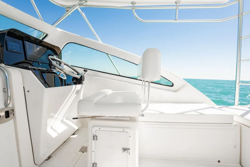 Slide: The Image of 2004 Luhrs Tournament 320 Open helm with ocean view and modern controls. - 20