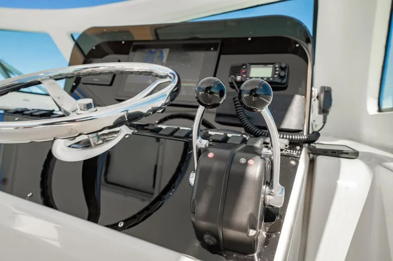 Slide: The Image of Helm of 2004 Luhrs Tournament 320 Open with steering wheel and throttle controls. - 24