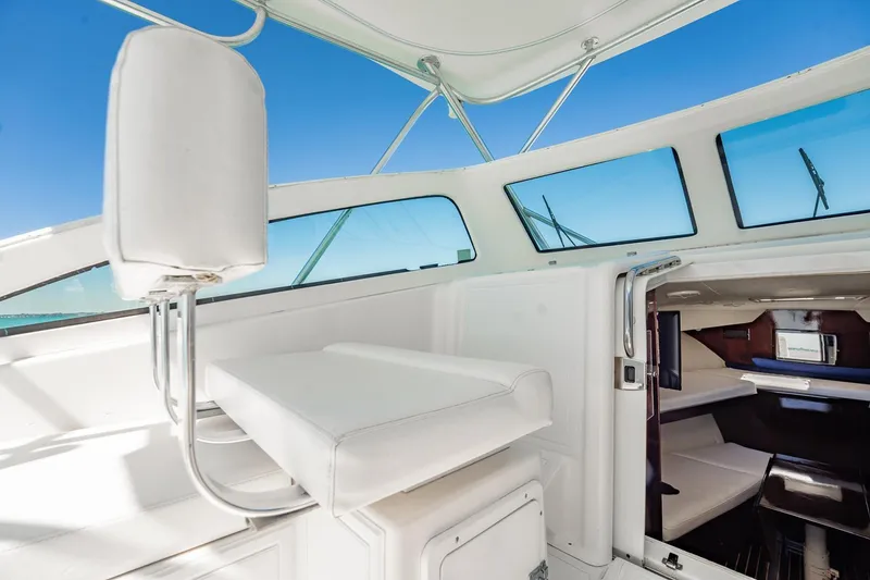 Slide: The Image of 2004 Luhrs Tournament 320 Open boat interior with white seating and cabin view. - 26