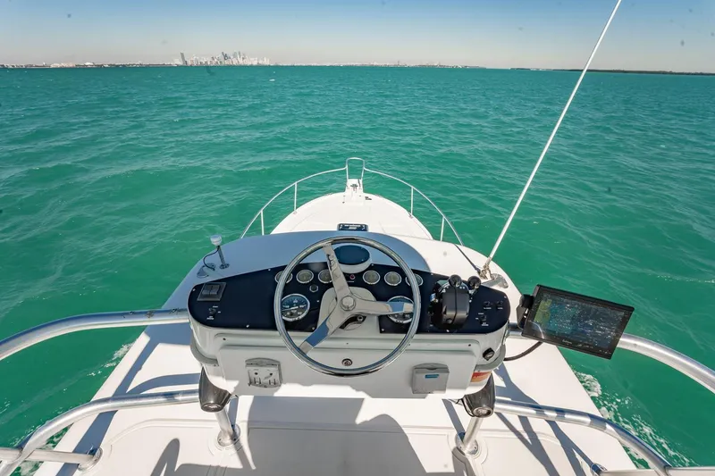 Slide: The Image of 2004 Luhrs Tournament 320 Open boat helm with ocean view and distant city skyline. - 28