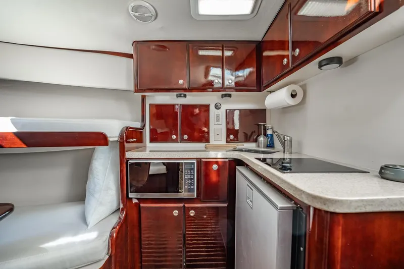 Slide: The Image of 2004 Luhrs Tournament 320 Open yacht interior with kitchenette and bunk bed. - 37