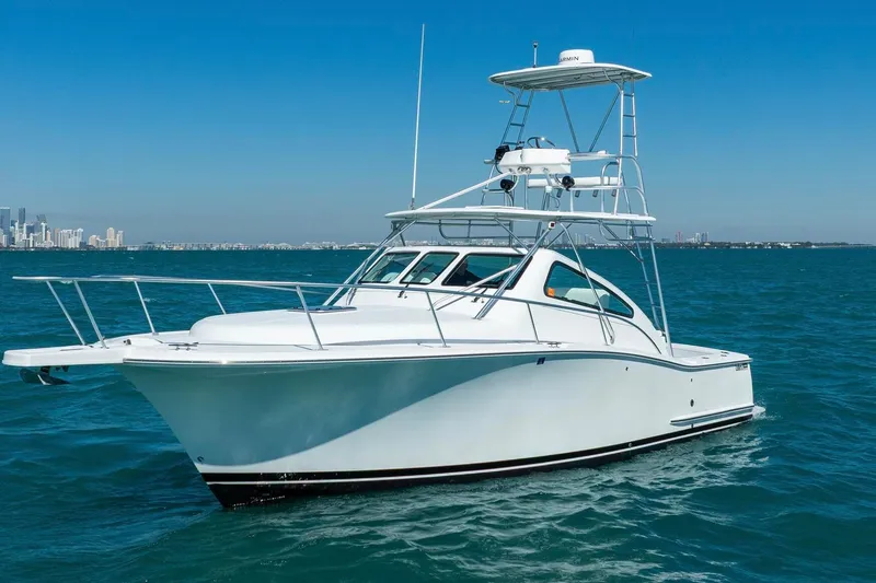 Slide: The Image of 2004 Luhrs Tournament 320 Open yacht cruising on blue ocean waters. - 5