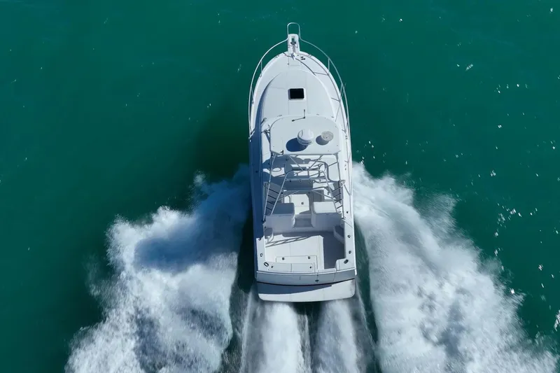 Slide: The Image of Aerial view of 2004 Luhrs Tournament 320 Open boat cruising on turquoise water. - 50
