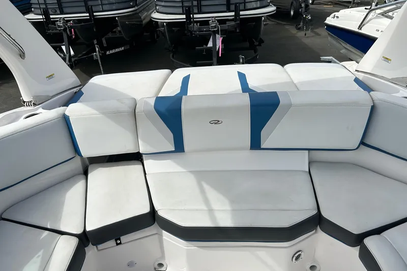 Slide: The Image of 2015 Regal 2000 ESX Bowrider boat with white and blue cushioned seating. - 11