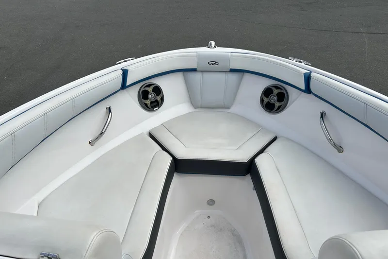 Slide: The Image of Interior of 2015 Regal 2000 ESX Bowrider, featuring white seating and stainless steel accents. - 13