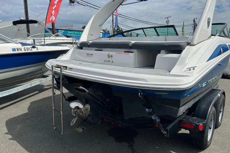 Slide: The Image of 2015 Regal 2000 ESX Bowrider boat on trailer, rear view with ladder and propeller. - 2