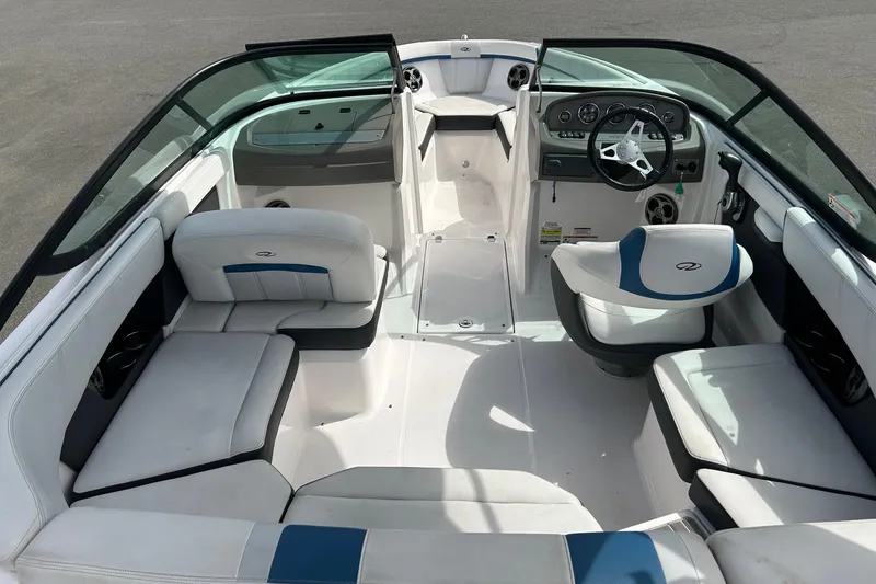 Slide: The Image of 2015 Regal 2000 ESX Bowrider interior with white and blue seating, steering wheel, and dashboard. - 4