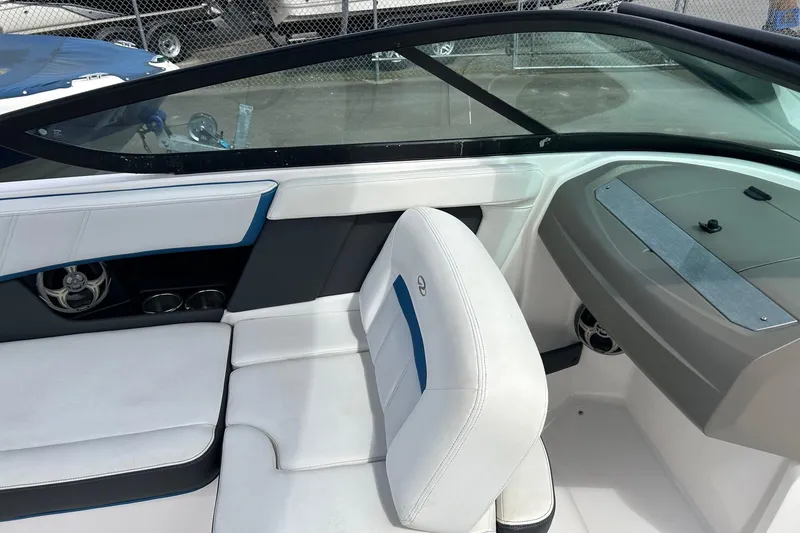Slide: The Image of Interior of a 2015 Regal 2000 ESX Bowrider boat with white seating and dashboard. - 7