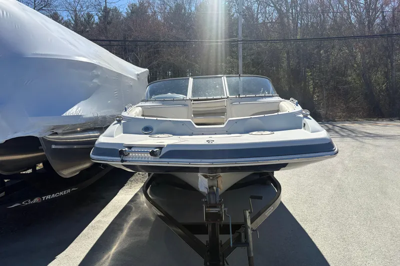 Slide: The Image of 2009 Tahoe 216 I/O WT boat on trailer, parked outdoors in sunlight. - 2