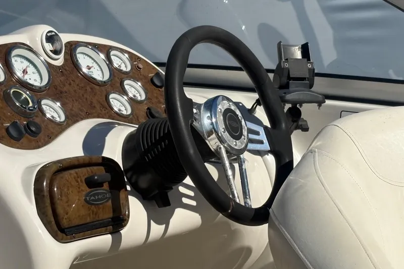 Slide: The Image of Steering wheel and dashboard of a 2009 Tahoe 216 I/O WT boat. - 4