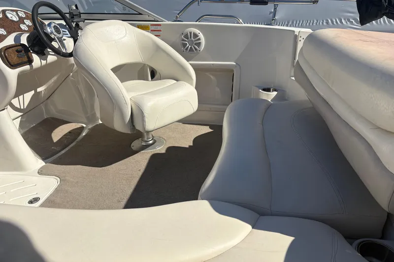 Slide: The Image of Interior of a 2009 Tahoe 216 I/O WT boat with white seating and steering console. - 5