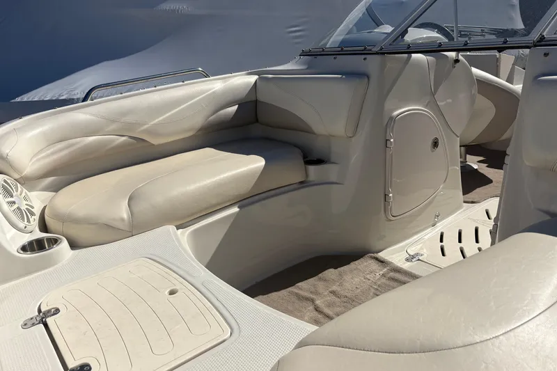 Slide: The Image of Interior of a 2009 Tahoe 216 I/O WT boat with beige seating and storage compartments. - 6