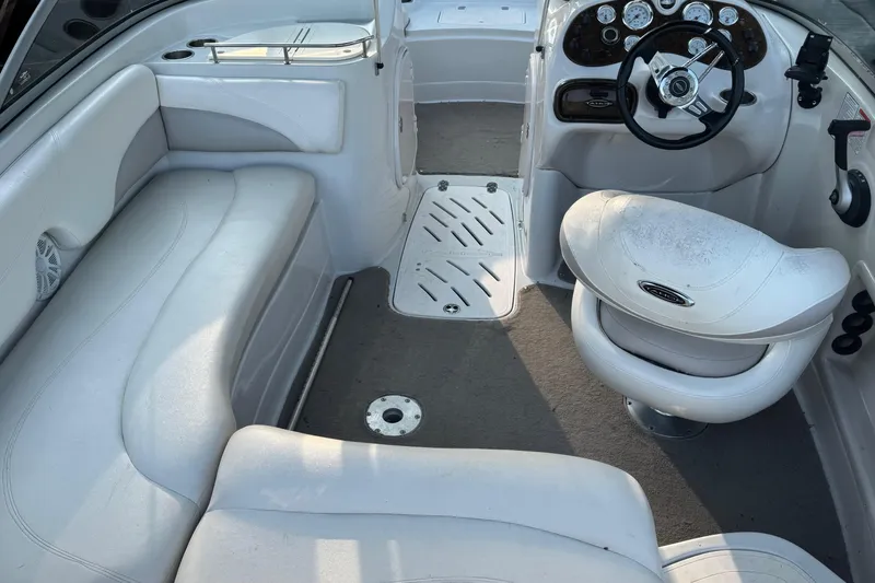Slide: The Image of 2009 Tahoe 216 I/O WT boat interior with white seating and steering console. - 7