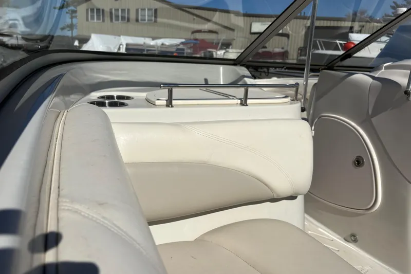 Slide: The Image of Interior of a 2009 Tahoe 216 I/O WT boat with white seating and cup holders. - 8