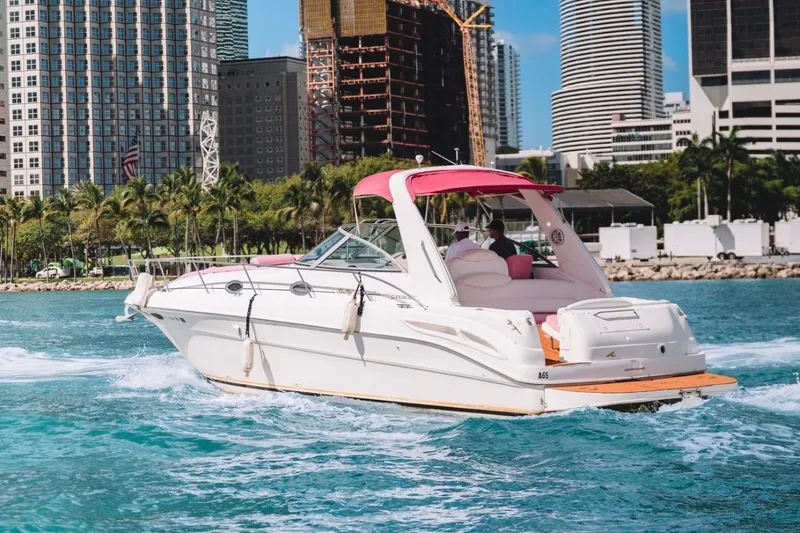 Slide: The Image of 2001 Sea Ray 360 Express Cruiser on vibrant blue water near city skyline. - 10