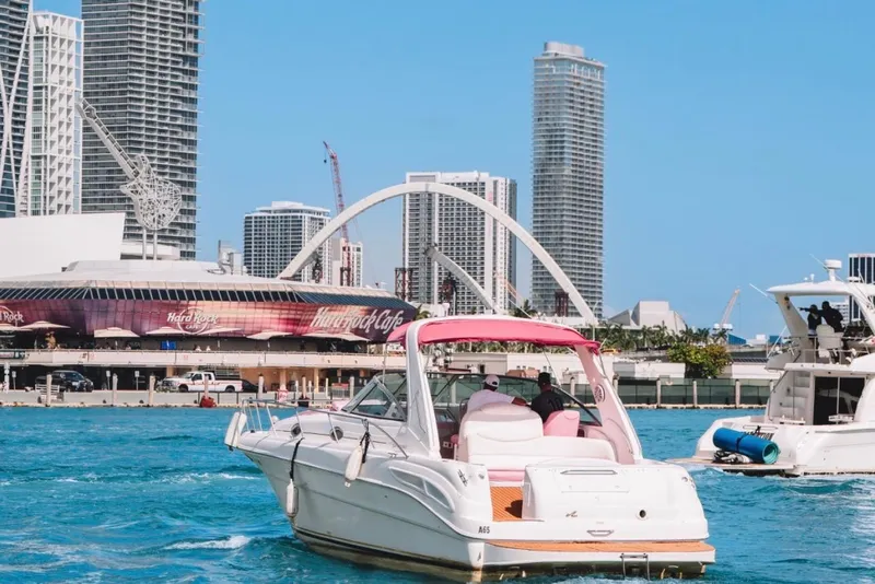 Slide: The Image of 2001 Sea Ray 360 Express Cruiser on vibrant city waterfront with skyscrapers and Hard Rock Cafe. - 11