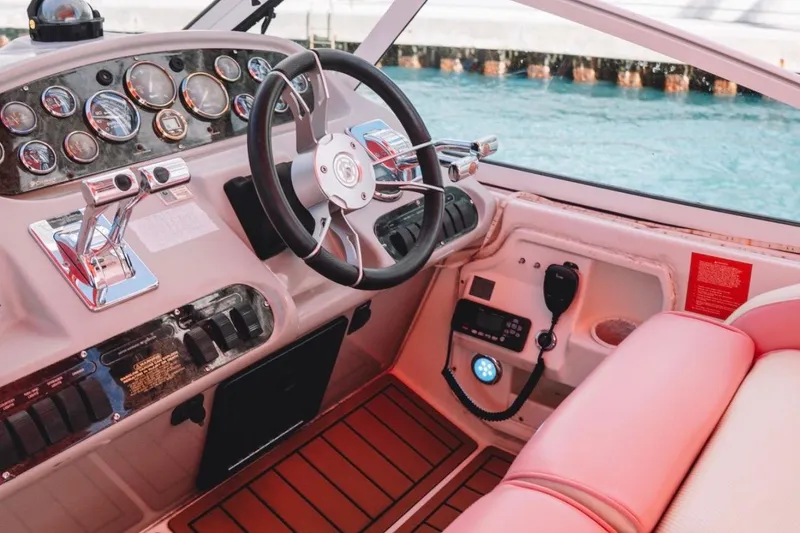 Slide: The Image of Cockpit of 2001 Sea Ray 360 Express Cruiser with steering wheel and control panel. - 14