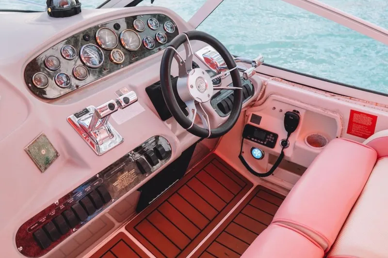 Slide: The Image of Helm of 2001 Sea Ray 360 Express Cruiser with gauges, steering wheel, and controls. - 15