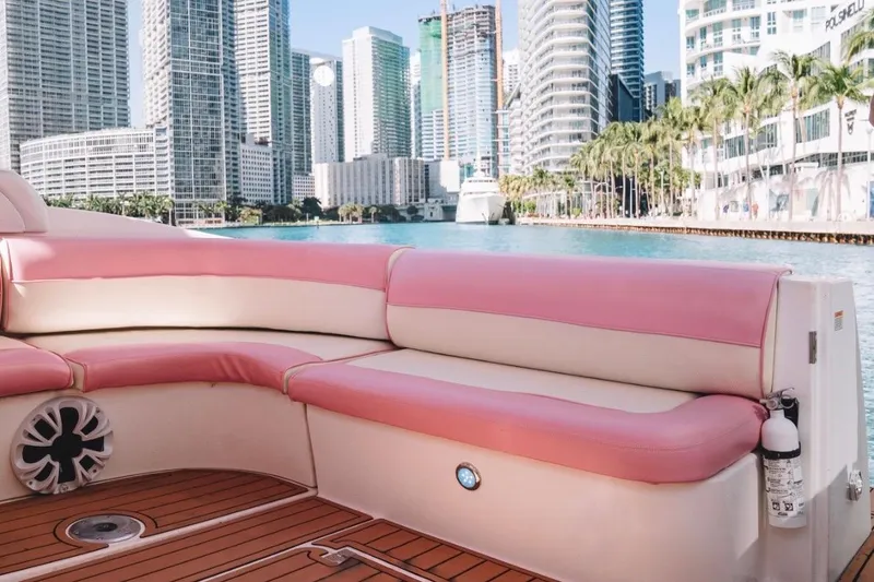 Slide: The Image of 2001 Sea Ray 360 Express Cruiser with pink seating, city skyline in background. - 17