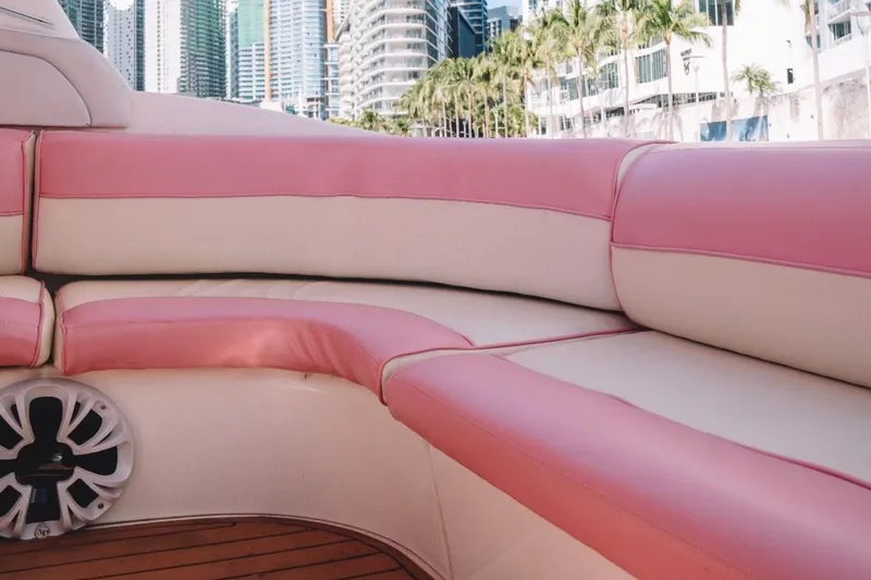 Slide: The Image of Pink and white seating on a 2001 Sea Ray 360 Express Cruiser with cityscape background. - 18