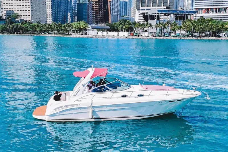 Slide: The Image of 2001 Sea Ray 360 Express Cruiser on turquoise water near city skyline. - 5