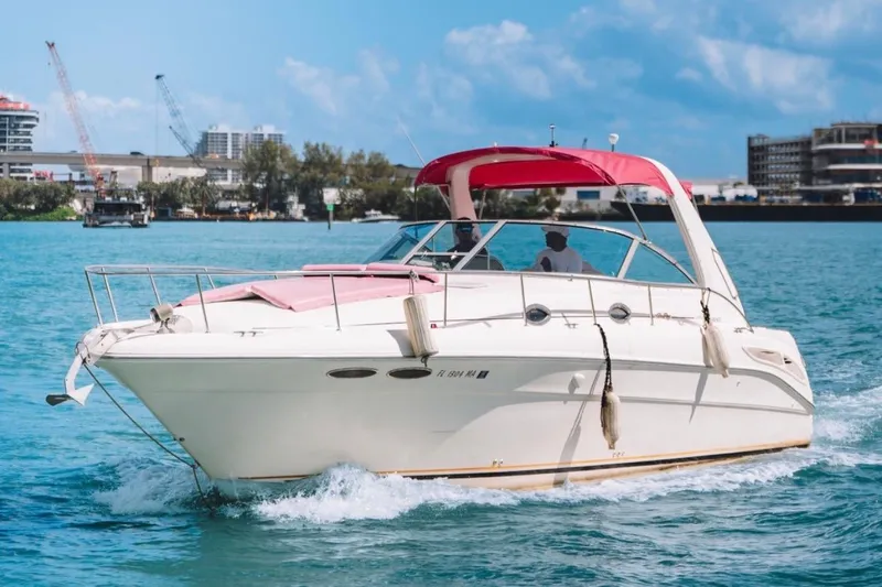 Slide: The Image of 2001 Sea Ray 360 Express Cruiser with red canopy cruising on blue water. - 6