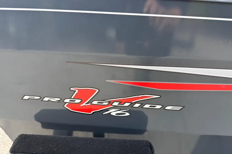 Slide: The Image of 2021 Tracker Pro Guide V-16 SC boat logo with red and silver accents. - 17