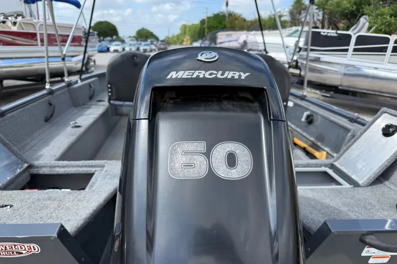 Slide: The Image of 2021 Tracker Pro Guide V-16 SC boat with Mercury 60 engine, docked outdoors. - 18