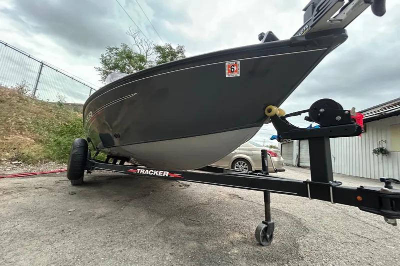 Slide: The Image of 2021 Tracker Pro Guide V-16 SC boat on trailer, parked outdoors. - 2
