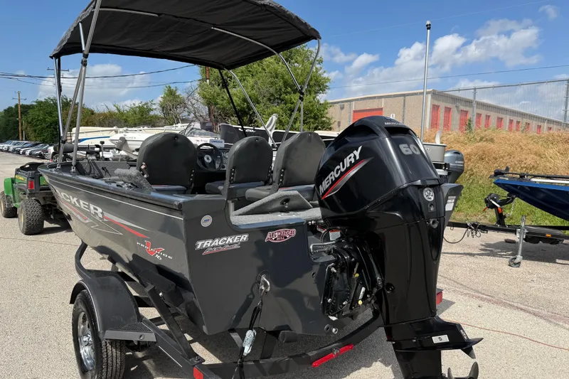 Slide: The Image of 2021 Tracker Pro Guide V-16 SC boat with Mercury 60 engine, parked outdoors. - 20