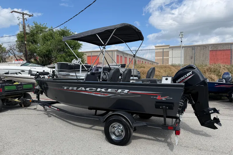 Slide: The Image of 2021 Tracker Pro Guide V-16 SC boat with Mercury engine on trailer, parked outdoors. - 21