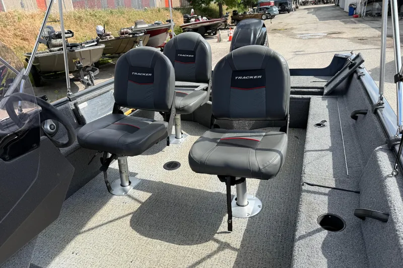Slide: The Image of 2021 Tracker Pro Guide V-16 SC boat interior with three cushioned seats. - 26